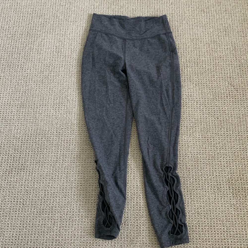 LuLuLemon leggings size 8 with cross stitch on bottom.